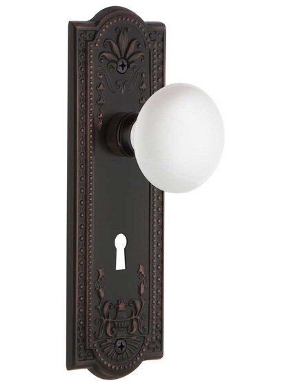 Meadows Door Set with White Porcelain Knobs and Keyhole in Timeless Bronze.
